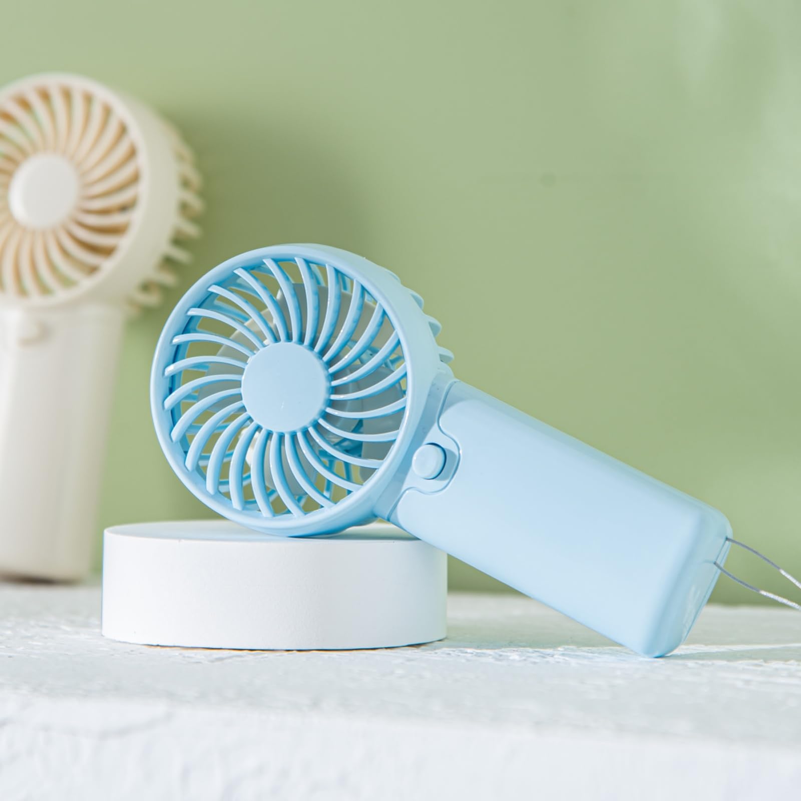 Battery operated mini desk fan with quiet operation, perfect for bedroom, camping, and travel cooling
