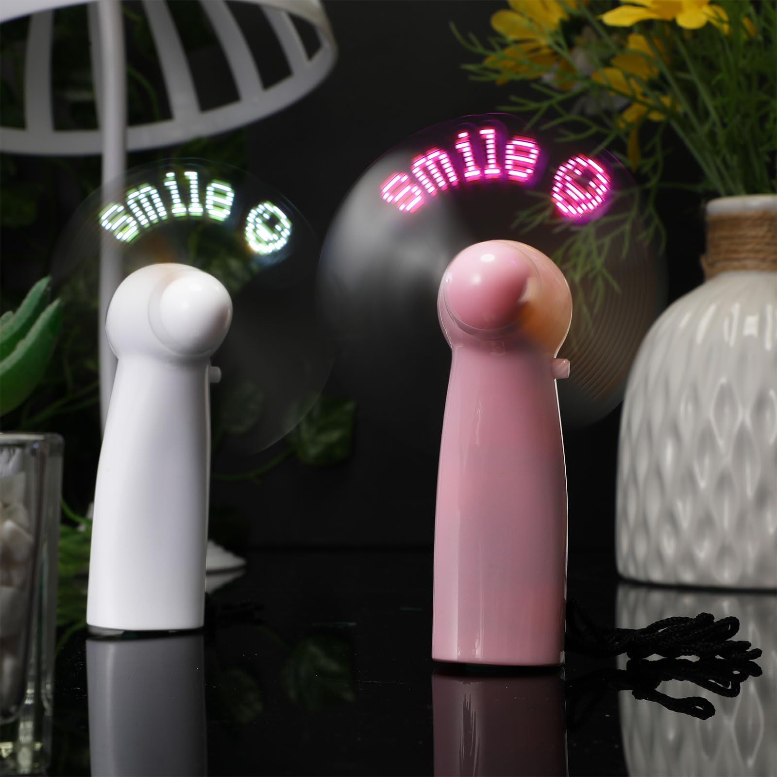 Personal handheld fans with LED light up smile face design great for summer cooling